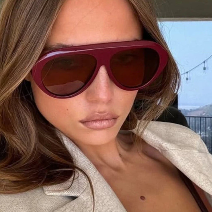 Person wearing maroon sunglasses with 'Murps' branding in the corner.