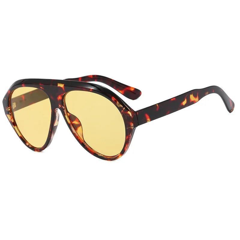 Sunglasses with tortoiseshell frame and yellow lenses on a white background