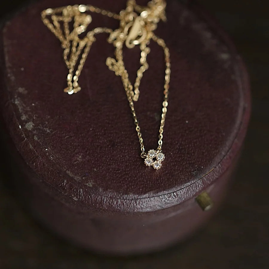 Dainty gold vermeil flower pendant necklace on model