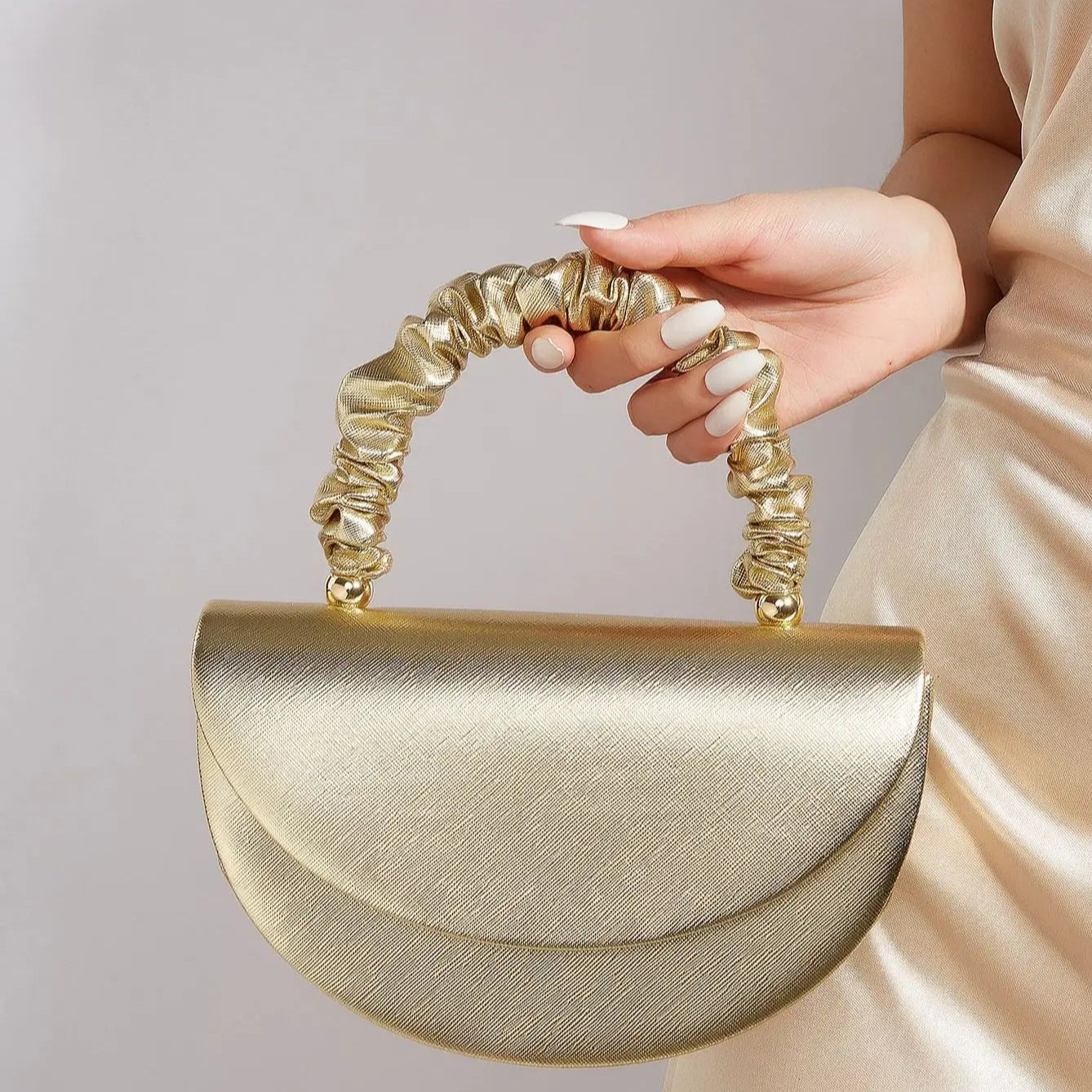 Gold ruched handle half-moon evening clutch, front view