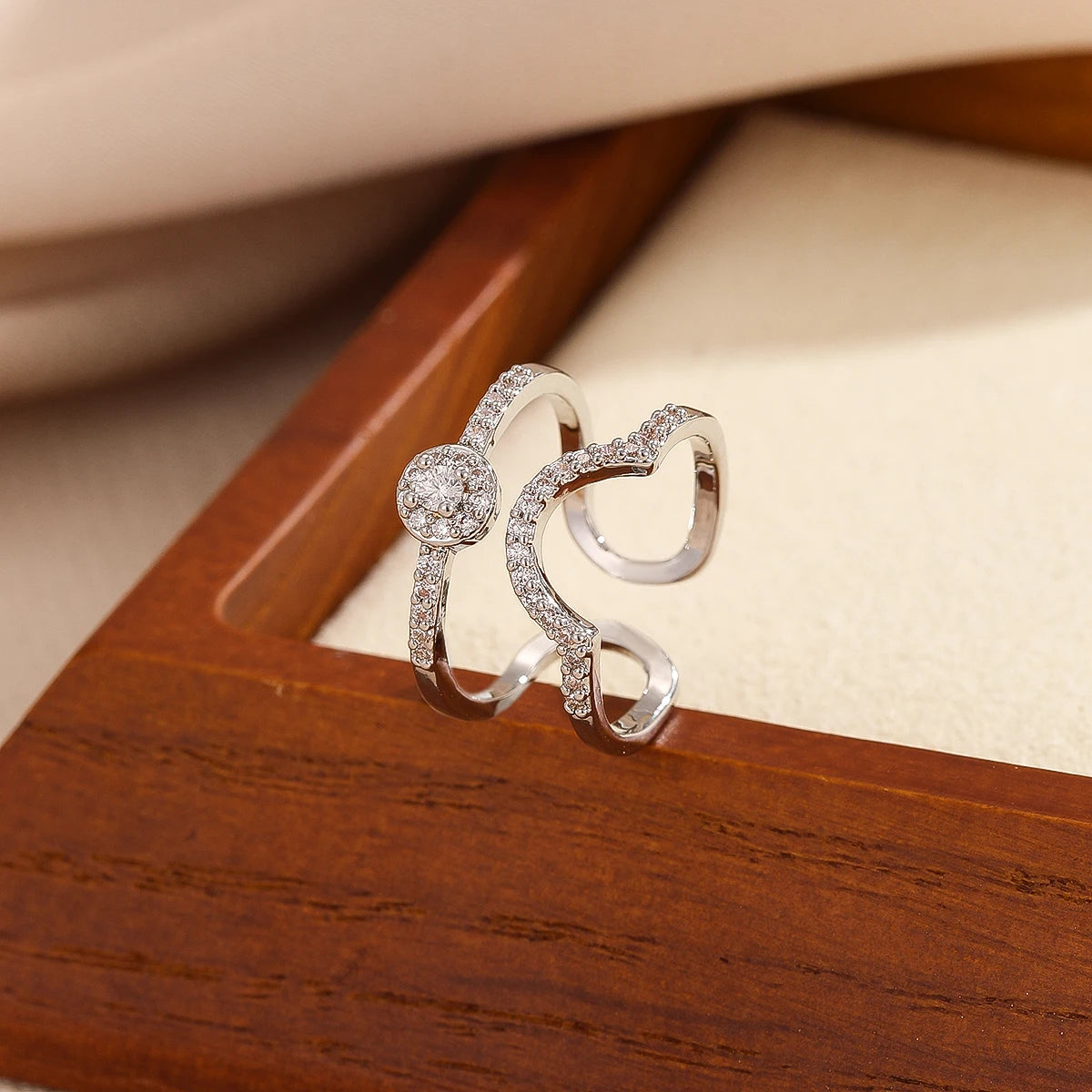 Gold pavé double-band adjustable ring with blue emerald-cut stone