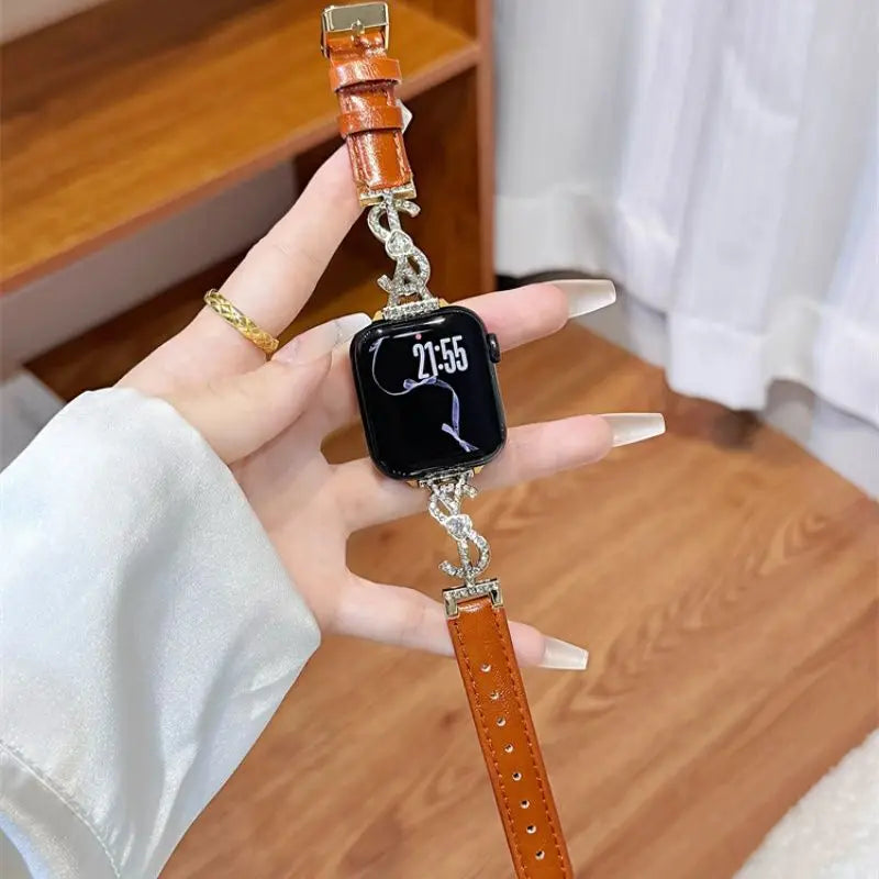 Brown leather Apple Watch band with crystal S links – display tray view