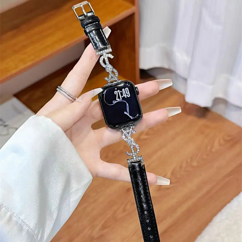 Black leather Apple Watch band with jeweled S connector – closeup on wrist