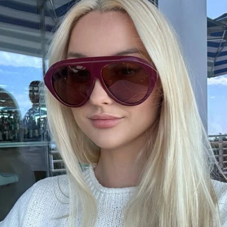Woman wearing large sunglasses with a blurred background