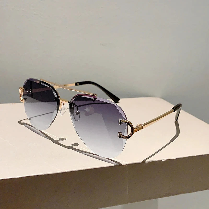 rimless aviator sunglasses with double bridge gold frame and black gradient lenses