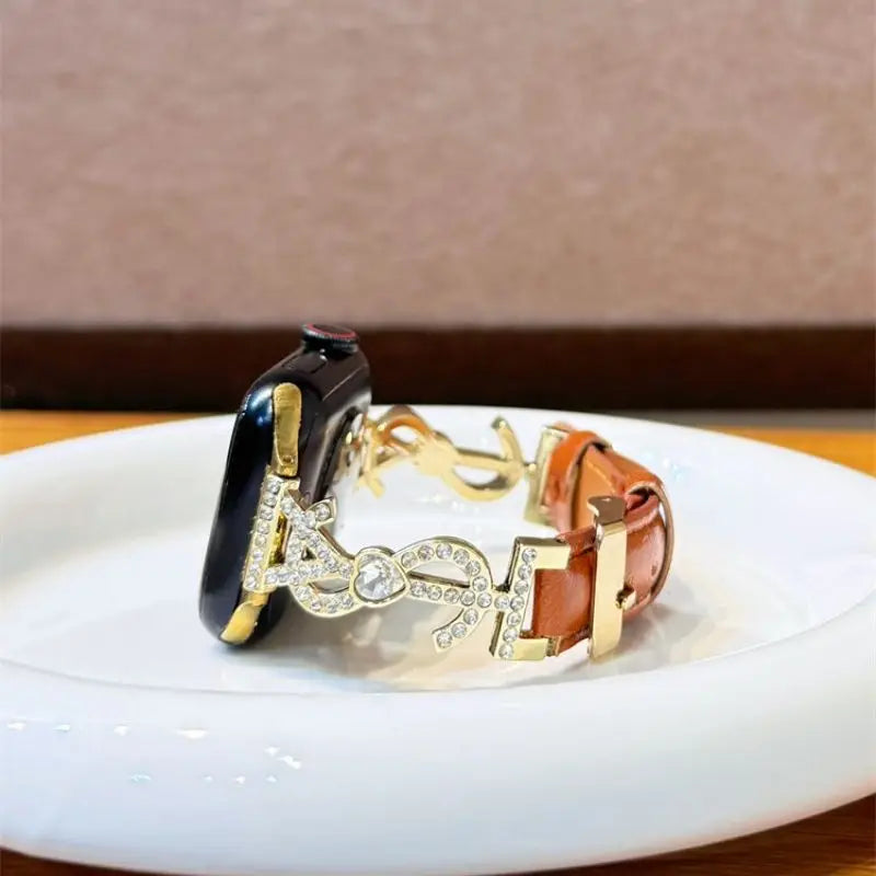 “Brown leather Apple Watch band with crystal S links – display tray view”