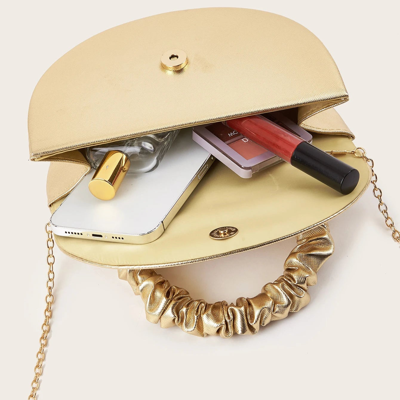 Gold ruched handle half-moon evening clutch, front view