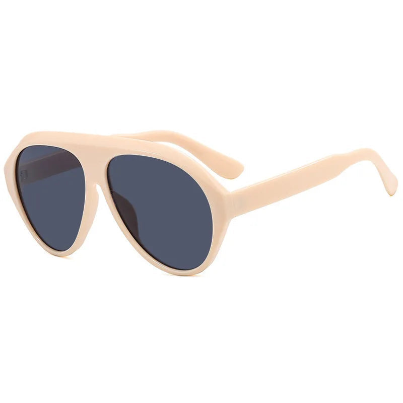 Beige sunglasses with dark lenses on a white background