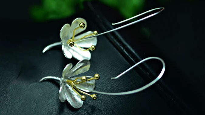 Close-up of silver flower earrings from Murps