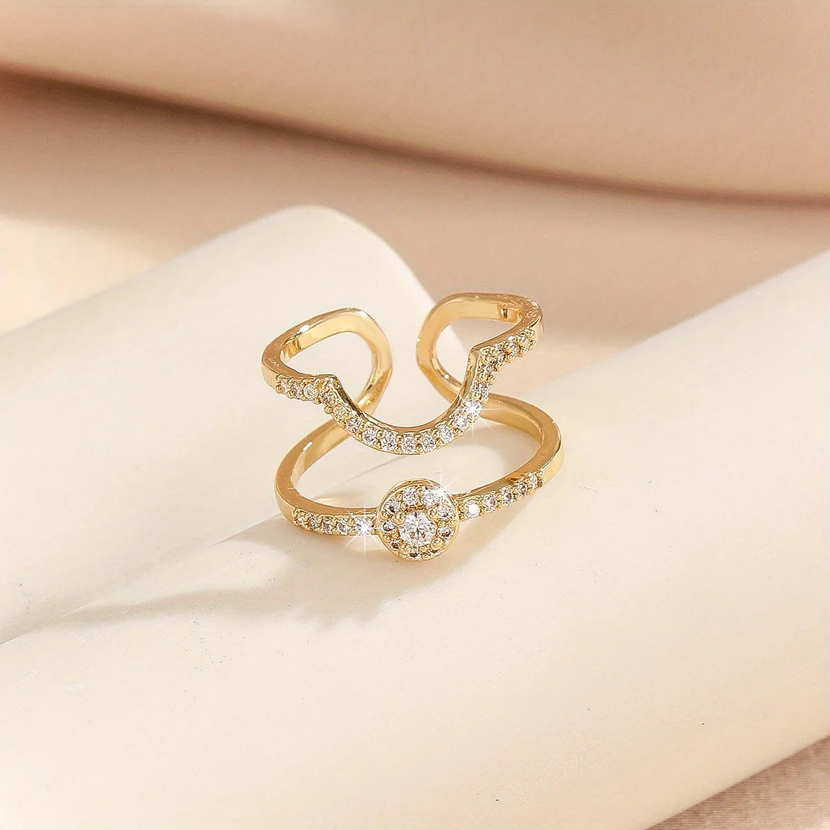 Gold pavé double-band adjustable ring with blue emerald-cut stone