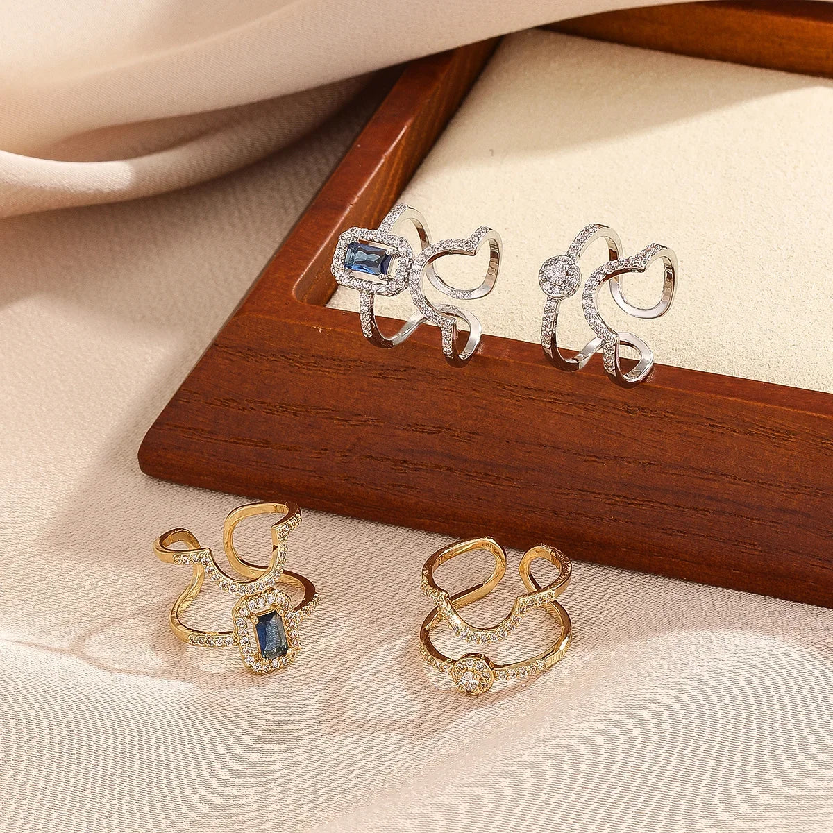 Gold pavé double-band adjustable ring with blue emerald-cut stone