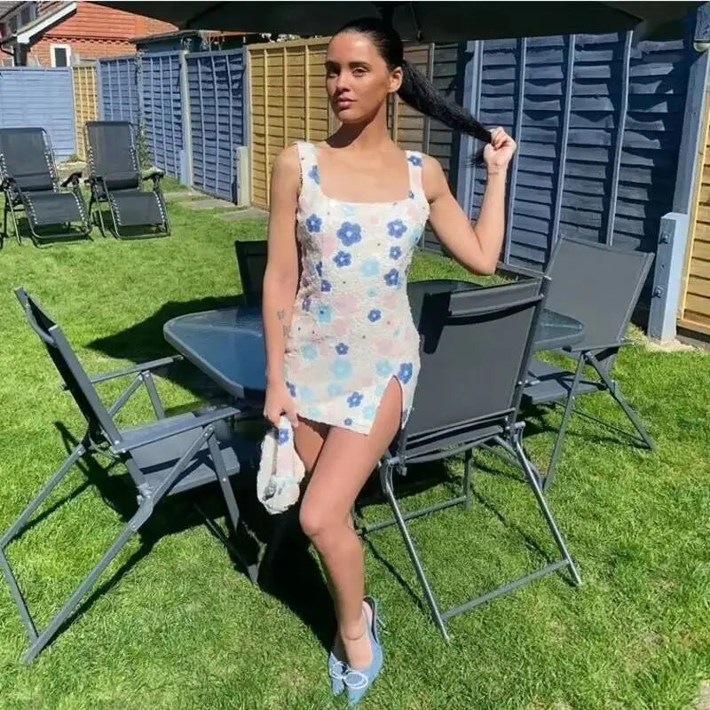 close up of floral sequin pattern on black mini party dress