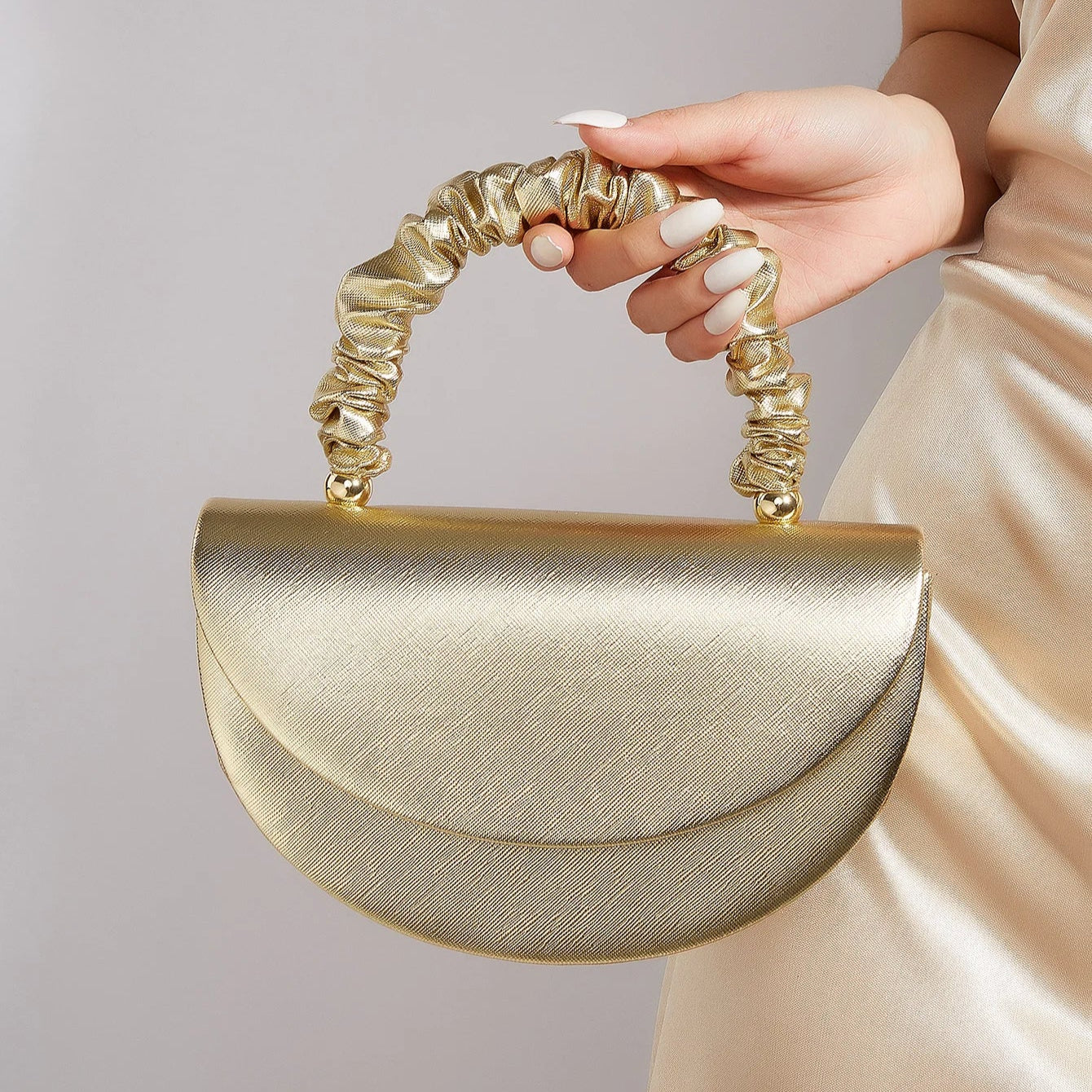 Gold ruched handle half-moon evening clutch, front view
