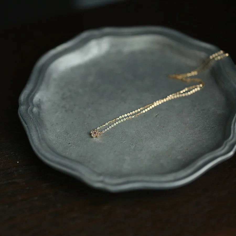 Dainty gold vermeil flower pendant necklace on model